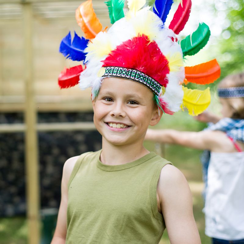 Boy wearing colorful headgear smiling