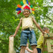 Wooden Climbing Cube with slide a kid smiling on top of the cube