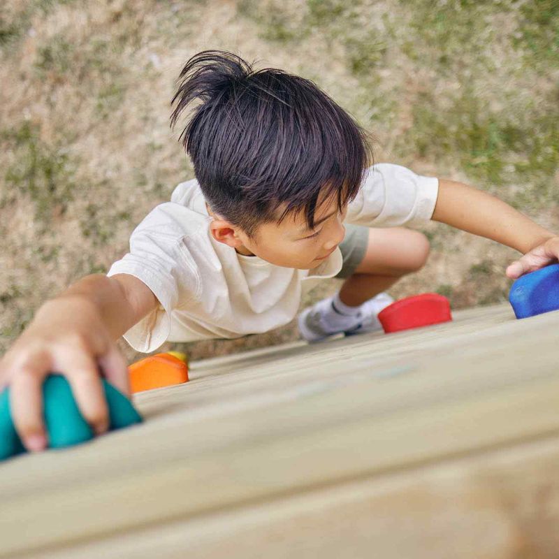 Boy climbing up the lookout Tower with Swings